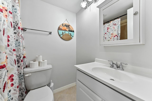 bathroom with toilet, tile patterned flooring, and vanity