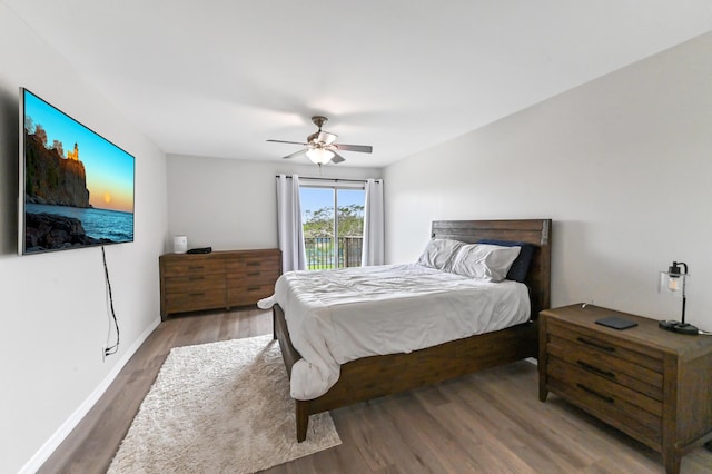 bedroom featuring hardwood / wood-style floors, ceiling fan, and access to exterior