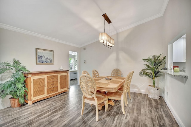 dining area featuring crown molding, a chandelier, and hardwood / wood-style flooring