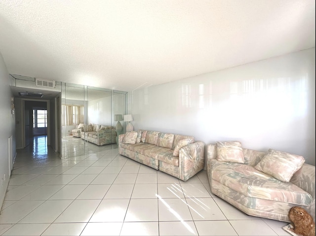 tiled living room with a textured ceiling