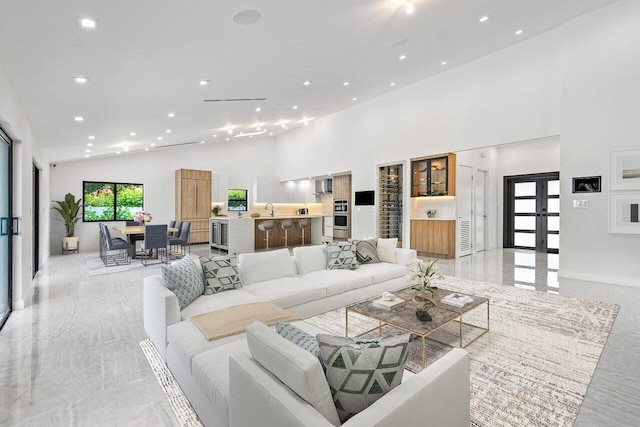 living room with high vaulted ceiling and french doors