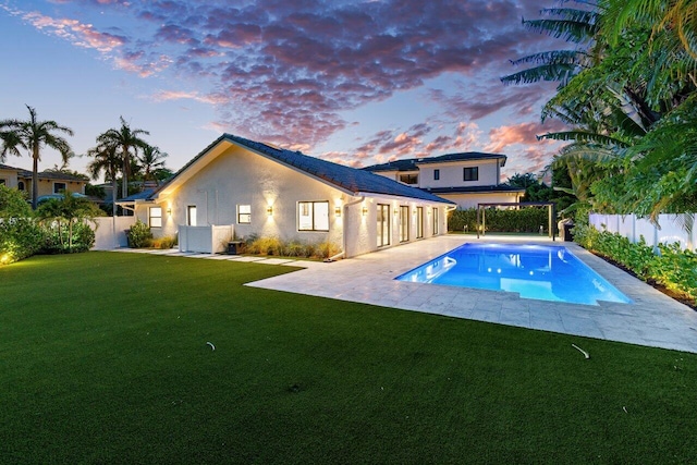 pool at dusk with a lawn