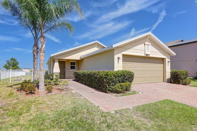 single story home with a garage and a front yard