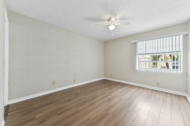 364 Capri H, Delray Beach, FL 33484 - spare room with a textured ceiling, ceiling fan, and wood-type flooring