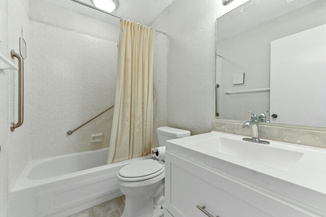 364 Capri H, Delray Beach, FL 33484 - full bathroom featuring shower / bath combo with shower curtain, vanity, tile patterned flooring, and toilet