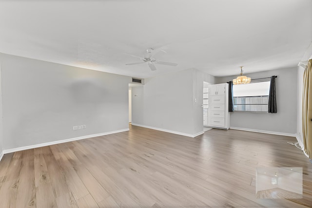 364 Capri H, Delray Beach, FL 33484 - spare room with ceiling fan with notable chandelier and light wood-type flooring