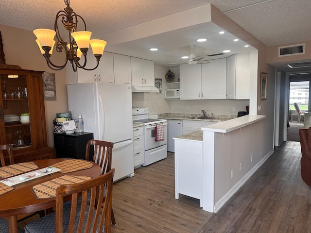 kitchen featuring sink, kitchen peninsula, white appliances, and white cabinets