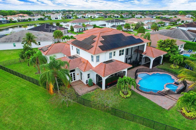 drone / aerial view featuring a water view and a residential view