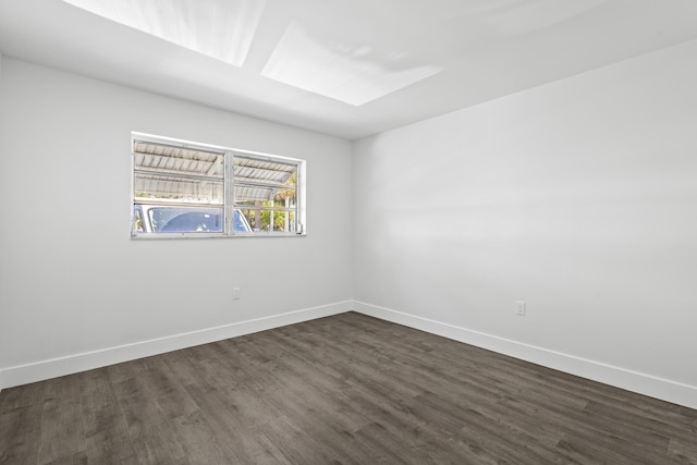 unfurnished room featuring dark hardwood / wood-style flooring