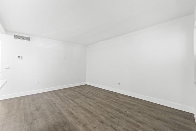 spare room featuring dark hardwood / wood-style floors