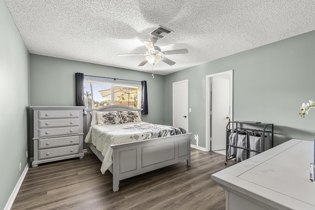 bedroom featuring visible vents, dark wood finished floors, and baseboards