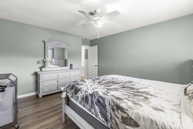 bedroom with a textured ceiling, ceiling fan, dark wood-style flooring, and baseboards