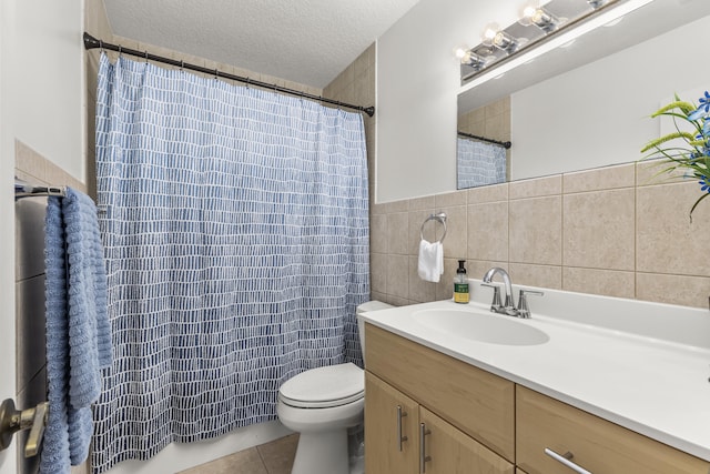 bathroom featuring a textured ceiling, toilet, vanity, tile walls, and tile patterned floors