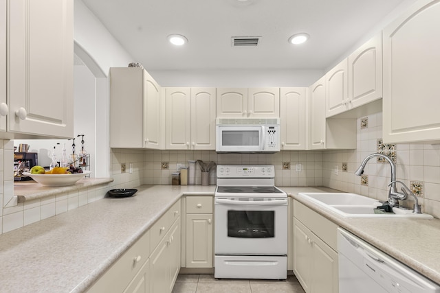 kitchen featuring light countertops, white appliances, visible vents, and white cabinets