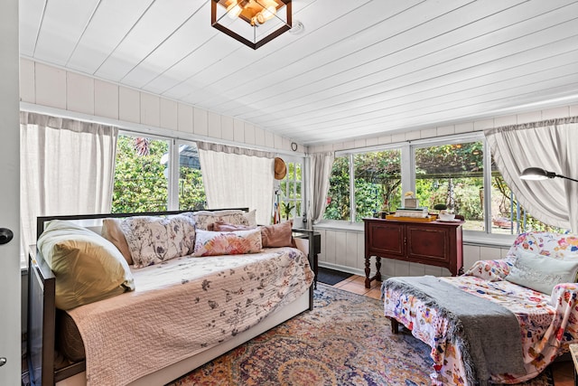 sunroom featuring vaulted ceiling and wood ceiling