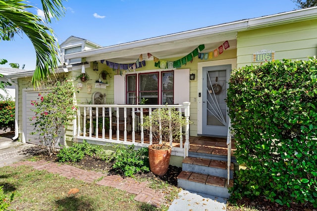 view of exterior entry with covered porch