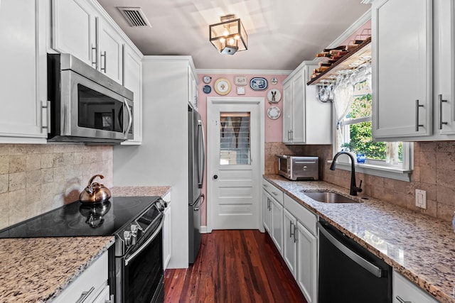 kitchen featuring stainless steel appliances and white cabinets