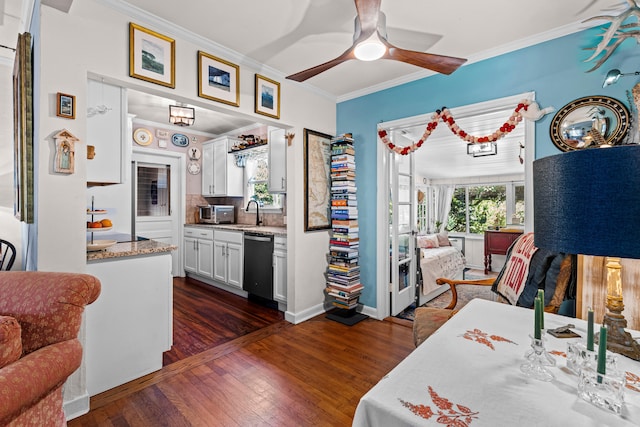 kitchen with white cabinetry, dark hardwood / wood-style flooring, tasteful backsplash, dishwasher, and crown molding