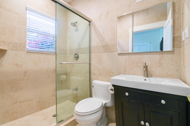 bathroom featuring tile walls, toilet, a stall shower, and vanity