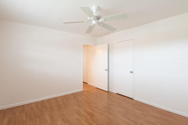 unfurnished bedroom featuring light wood-style floors, baseboards, and ceiling fan