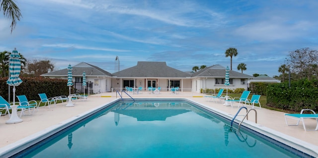 community pool featuring a patio area and fence