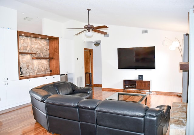 living room featuring vaulted ceiling, ceiling fan, and light wood-type flooring