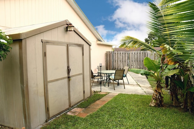 view of outbuilding featuring a lawn