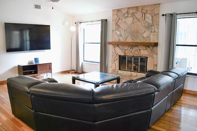 living room featuring hardwood / wood-style flooring, plenty of natural light, and a fireplace