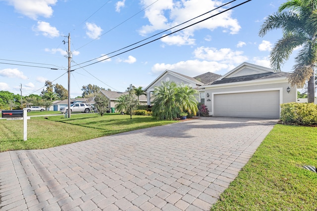 view of front of home featuring a garage and a front yard