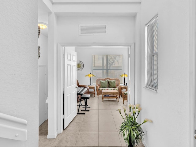 corridor with light tile patterned floors