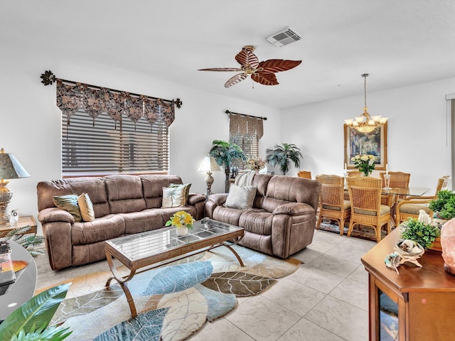 tiled living room featuring ceiling fan with notable chandelier