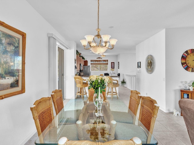 tiled dining space with a notable chandelier