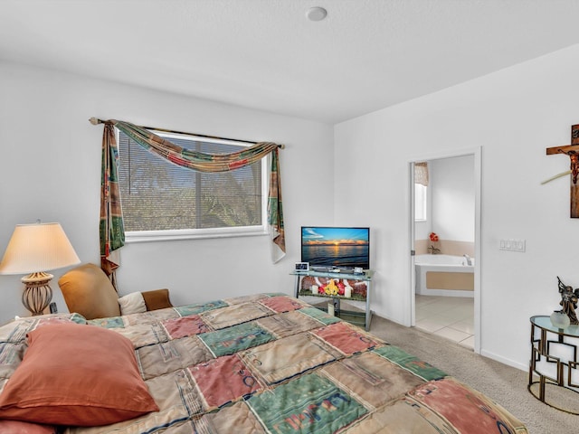 bedroom with light colored carpet and ensuite bathroom