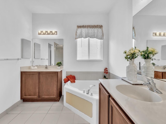 bathroom with vanity, a tub to relax in, and tile patterned floors