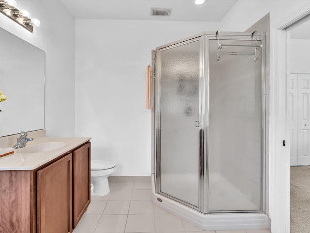 bathroom with walk in shower, vanity, toilet, and tile patterned flooring