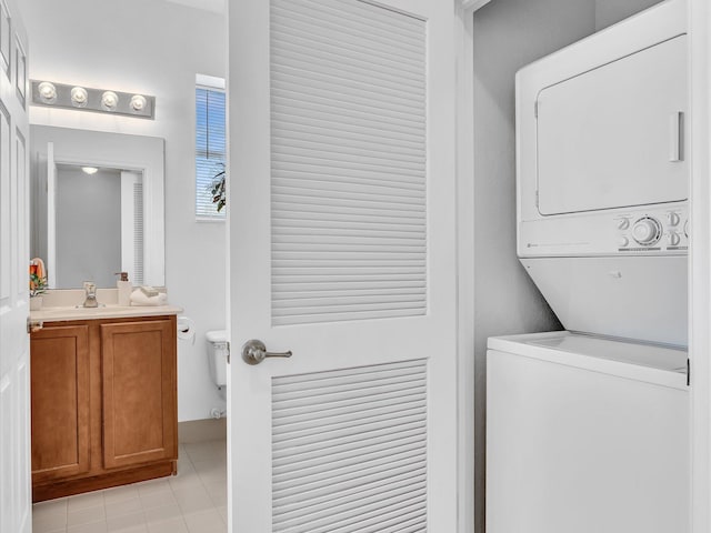 laundry room with stacked washer / drying machine and sink