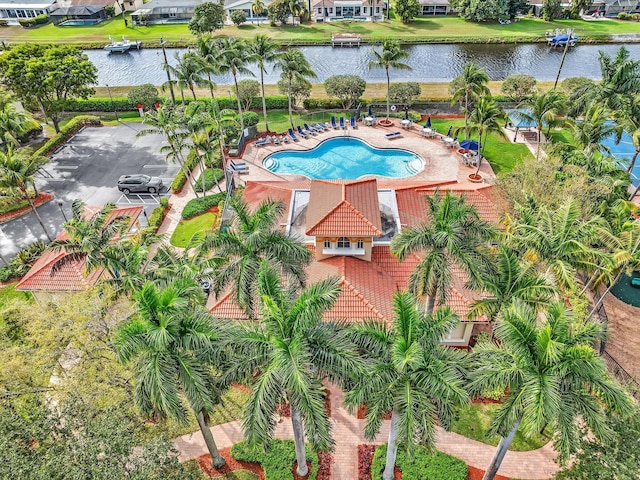 view of pool featuring a patio and a water view