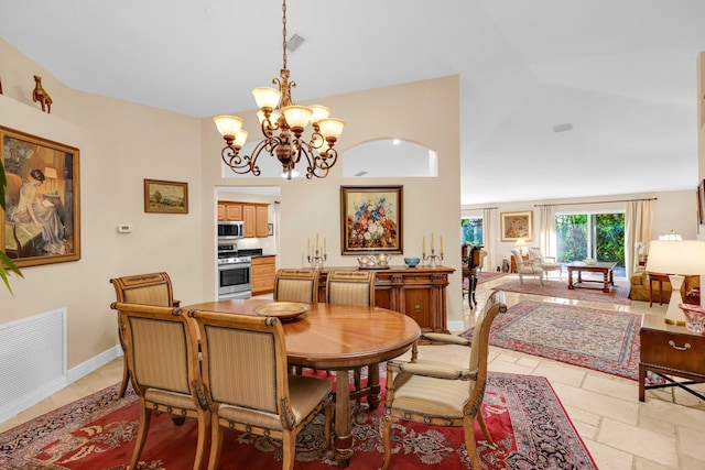 dining area with lofted ceiling and a chandelier