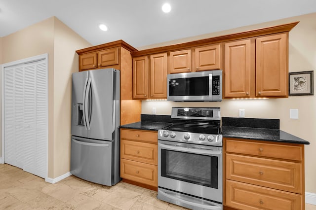 kitchen featuring appliances with stainless steel finishes and dark stone countertops