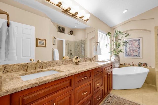 bathroom featuring vanity, vaulted ceiling, tile patterned floors, and shower with separate bathtub