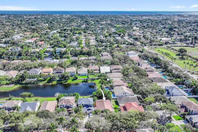 birds eye view of property with a water view