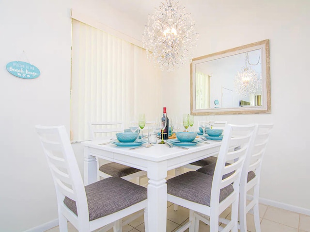 tiled dining room featuring a chandelier