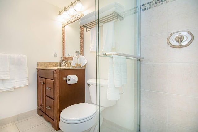 bathroom with tile patterned flooring, vanity, a shower with door, and toilet