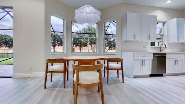 dining space featuring sink and light hardwood / wood-style floors