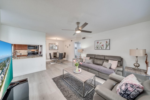 927 Riverside Dr Unit 313, Coral Springs, FL 33071 - living room with light wood finished floors and ceiling fan
