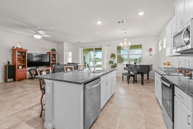kitchen with white cabinets, visible vents, appliances with stainless steel finishes, and a sink