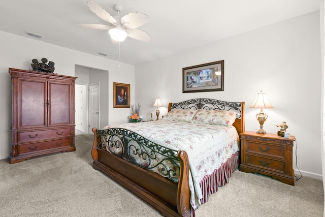 carpeted bedroom with baseboards, a ceiling fan, and visible vents