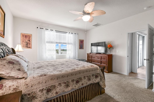 bedroom with light colored carpet, ceiling fan, baseboards, and visible vents