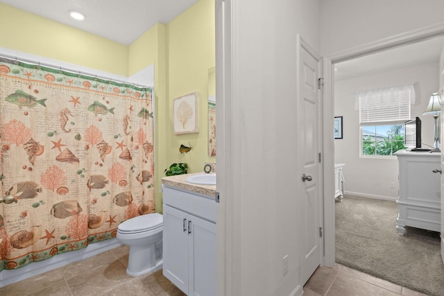bathroom featuring toilet, a shower with curtain, vanity, and tile patterned floors