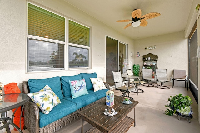 sunroom featuring a ceiling fan and outdoor lounge area